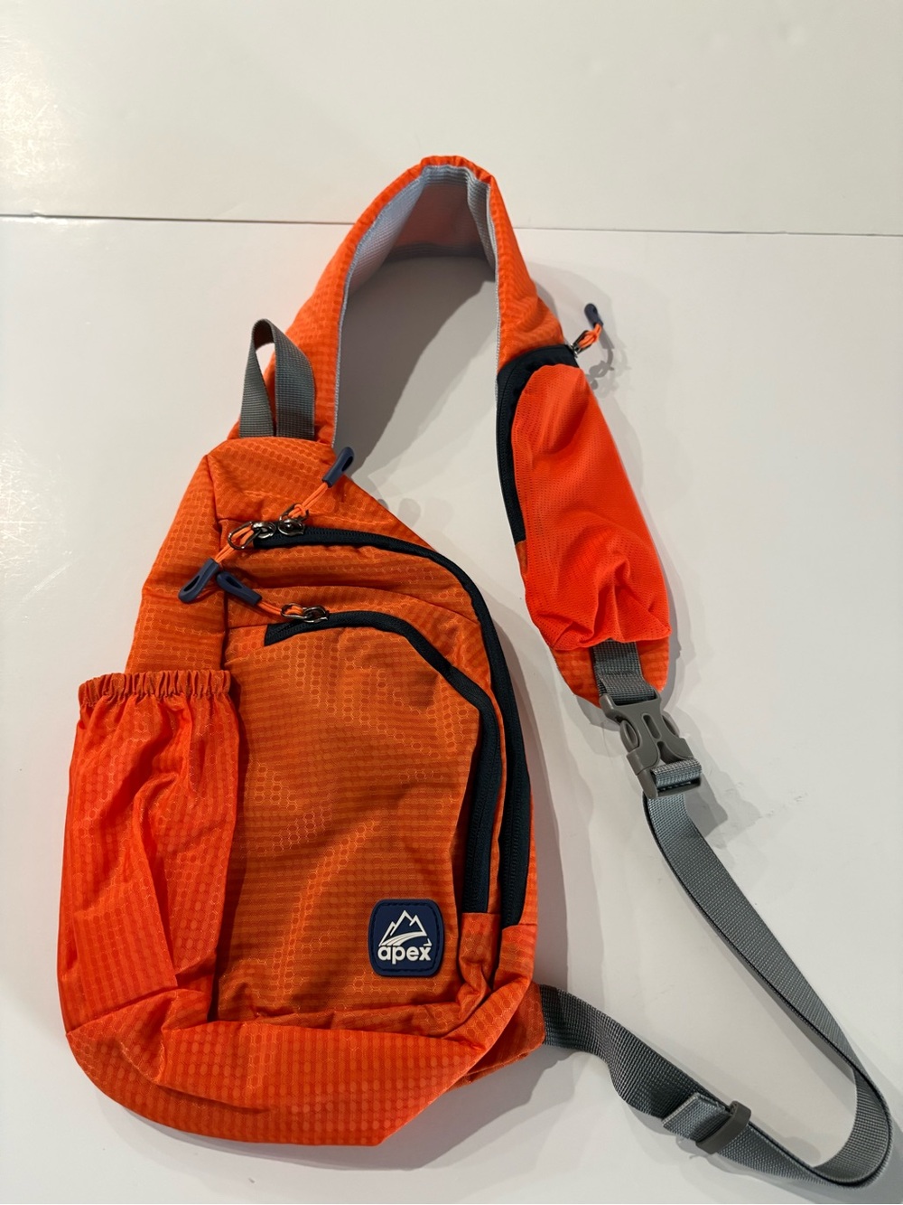 Apex Orange Crossbody Sling Bag with a padded shoulder strap and lots of pockets